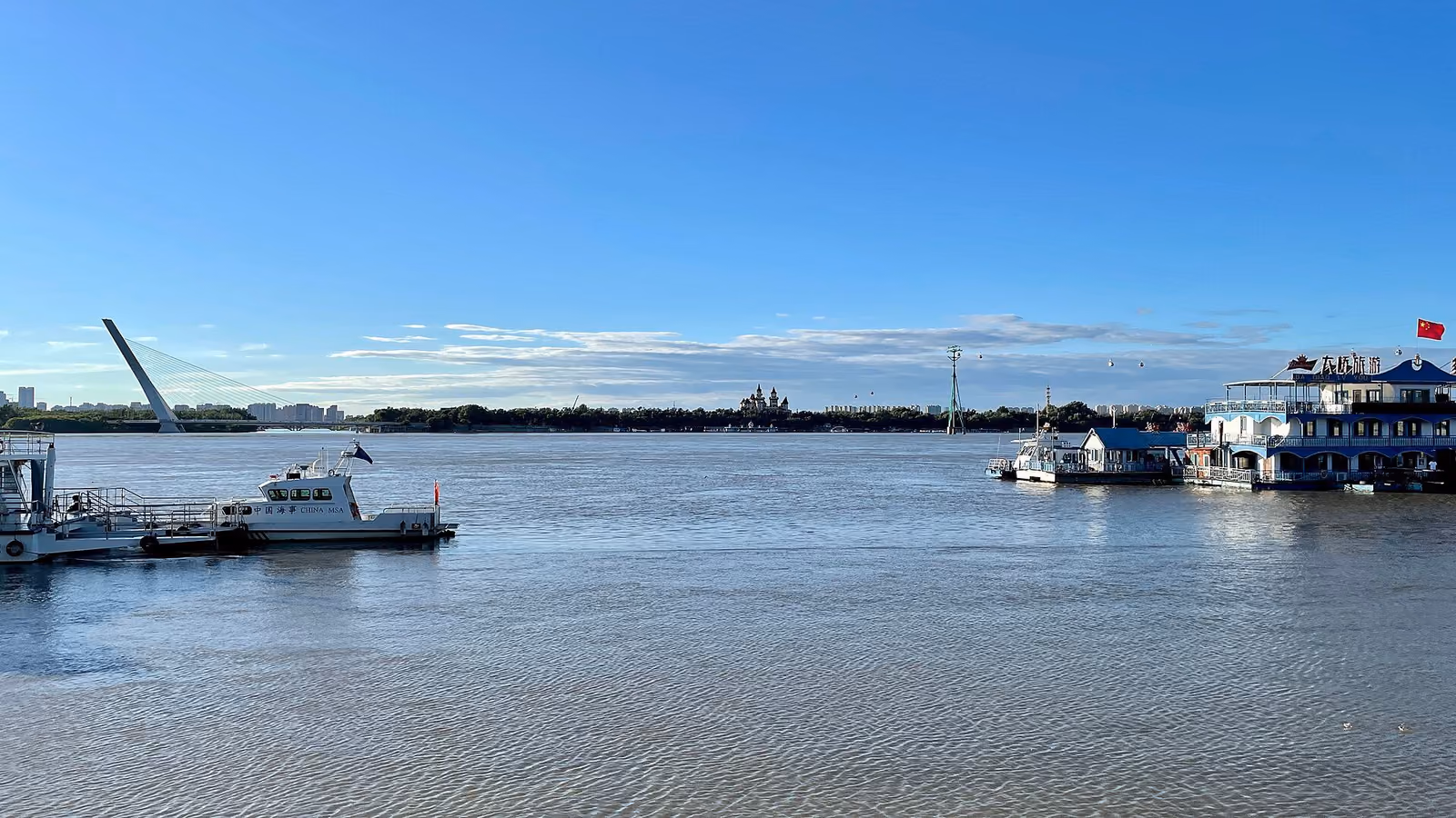 Passenger boats and the riverfront beside the Songhua River in Harbin
