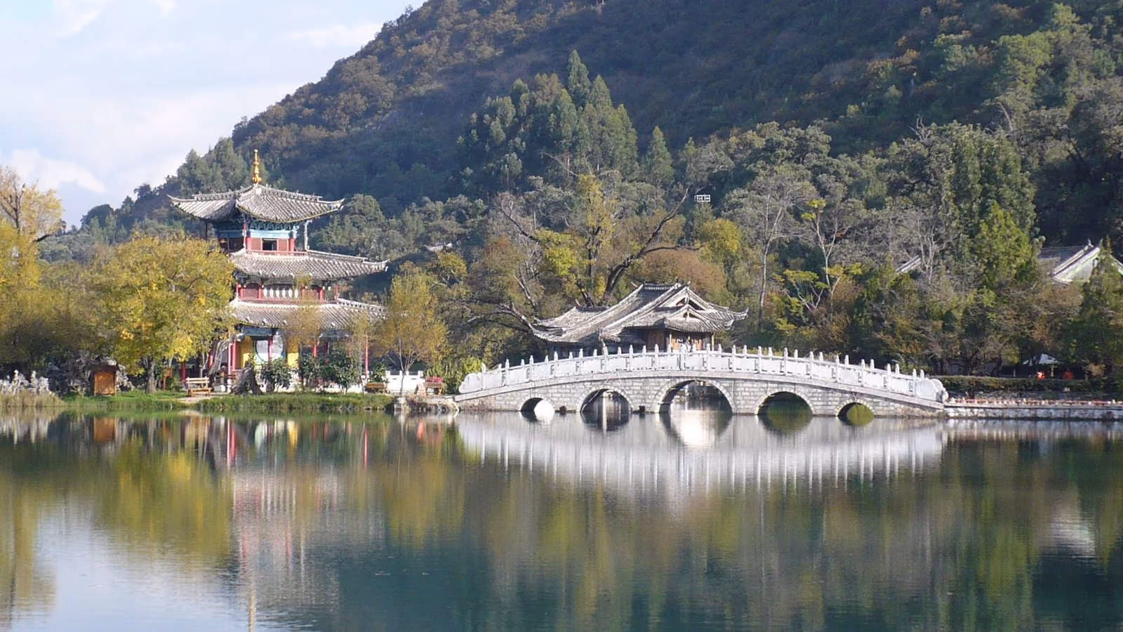 Stone bridge and pavilions reflected in Black Dragon Pool, Lijiang