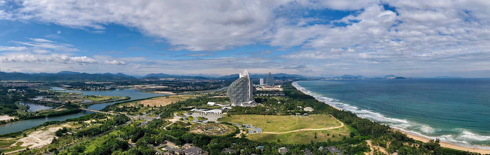 A wide view along Haitang Bay's resort coast in Sanya