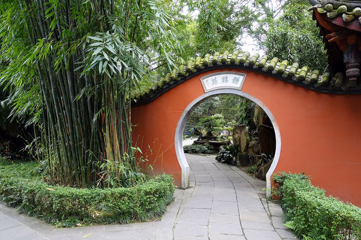 A garden gateway framed by red walls and bamboo at Wuhou Shrine, Chengdu