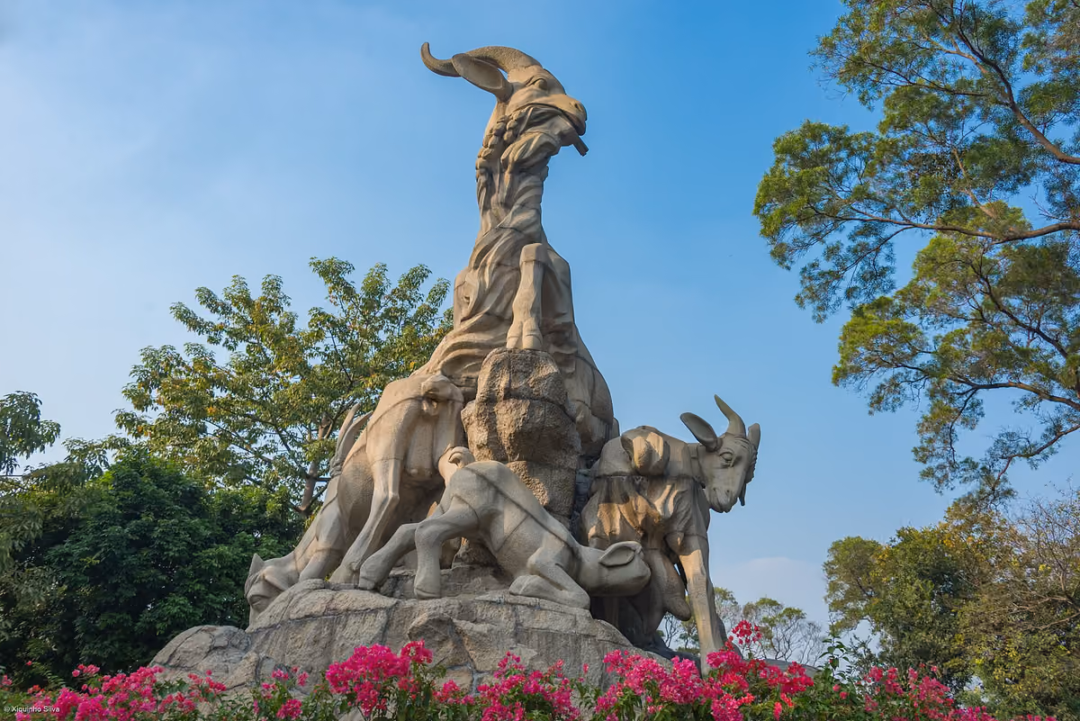The Five-Ram Sculpture surrounded by trees in Yuexiu Park, Guangzhou