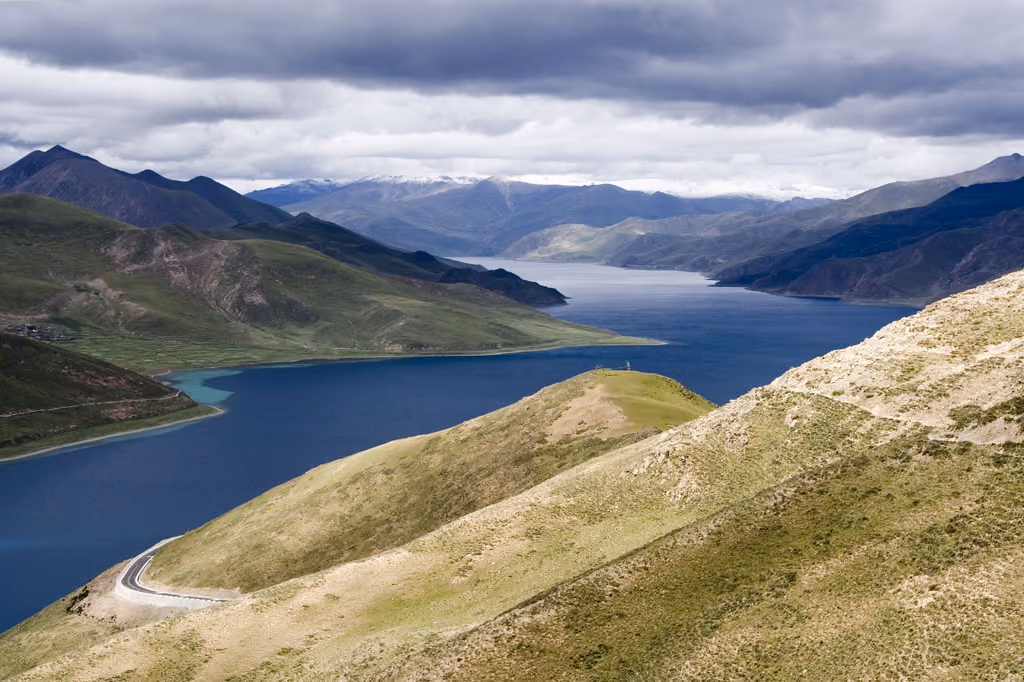 Turquoise Yamdrok Lake winding between the mountains of Tibet