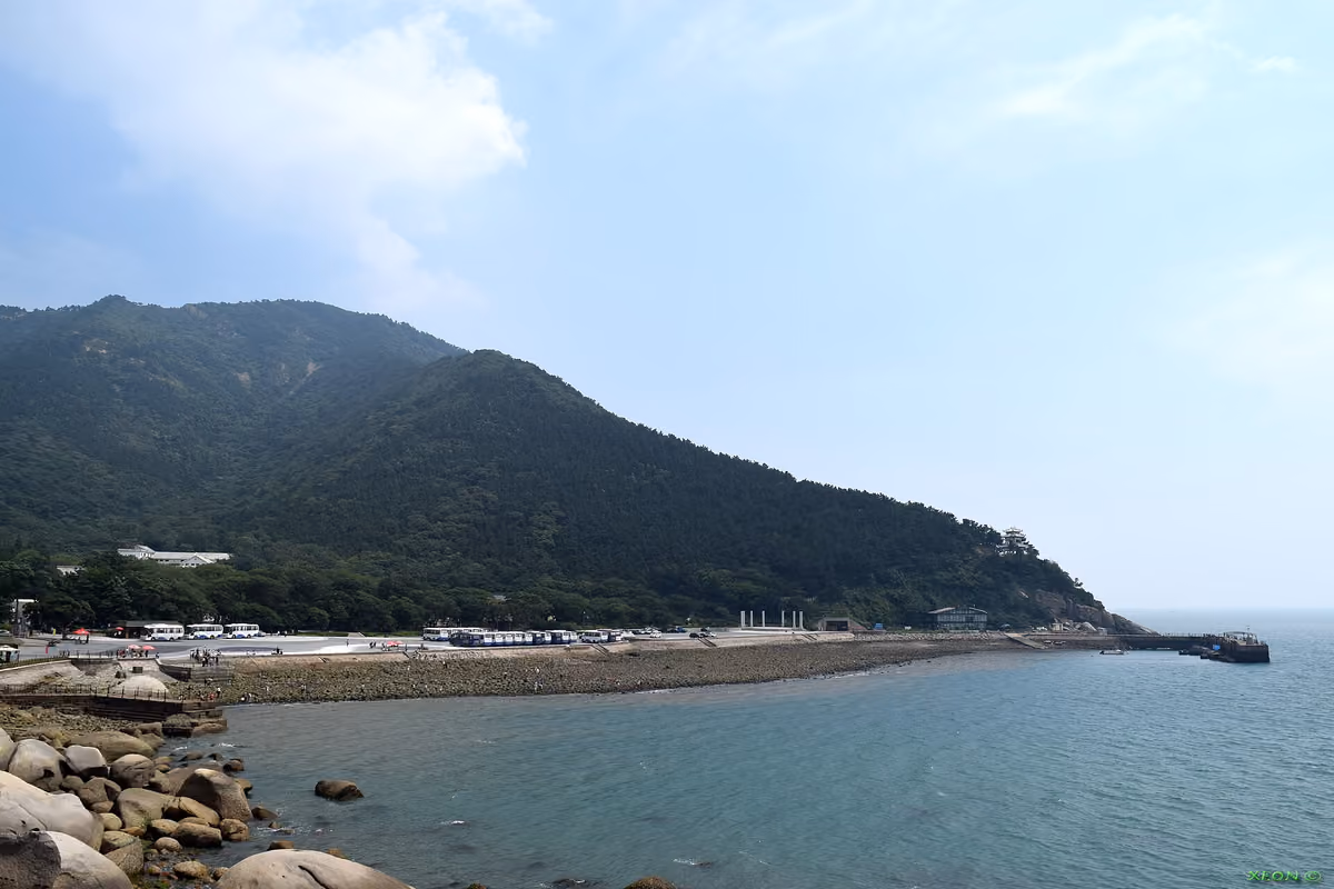 Green mountains meet the sea along the Laoshan coast near Qingdao