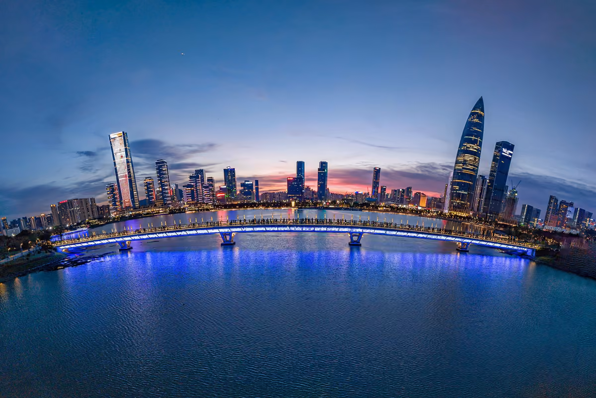 Bridge at Shenzhen Talent Park with the illuminated Shenzhen Bay skyline